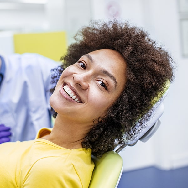 A woman at the dentist waiting for her oral hygiene