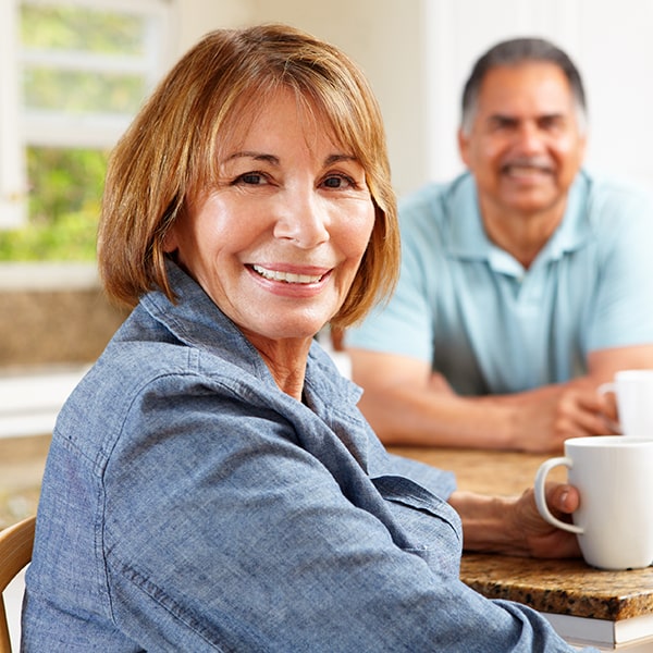 See how the dental extraction procedure works with these three simple steps An older couple sitting at the table drinking coffee and smiling