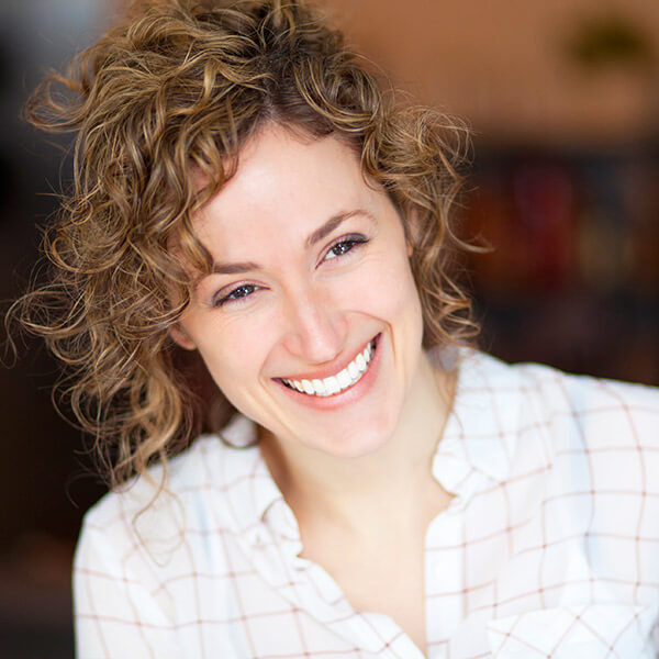 A woman smiling after her tooth extraction