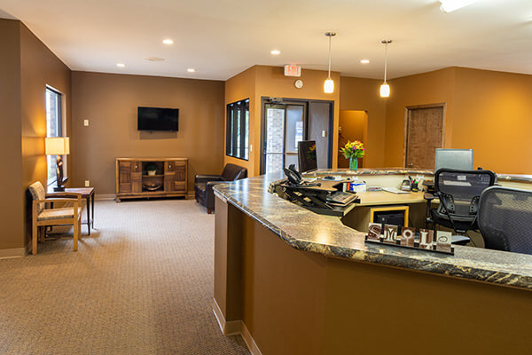 Dr. Alm takes care of your smile and your whole-body health. Horizon Dental's office front desk and waiting room.
