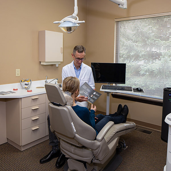 Dr. Alm explaining to a patient difference payment plans